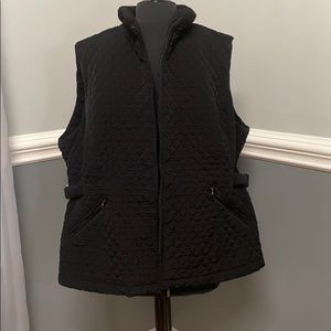 Vest with zip front and zippered pockets.